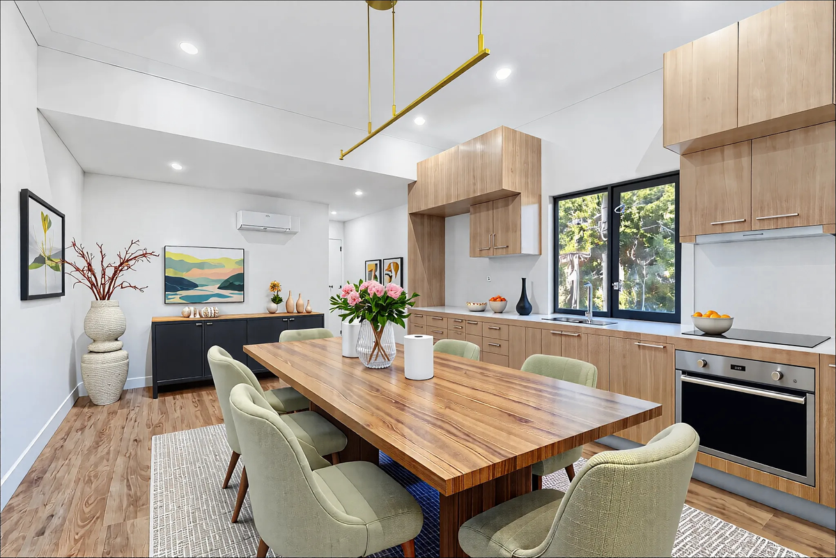 Modern kitchen with wood cabinets and integrated dining area