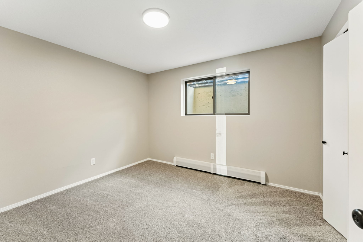 Simple room with neutral walls ideal for office setup
